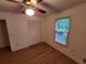Bedroom featuring wood floors, a window with blinds, a closet, and a ceiling fan at 3054 Whisper Knob Rd, Marietta, GA 30062