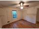 This bedroom features a ceiling fan, hardwood floors, and a bright window at 3054 Whisper Knob Rd, Marietta, GA 30062
