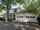 Charming two-story home with a white exterior and a large front-facing garage at 3054 Whisper Knob Rd, Marietta, GA 30062