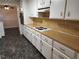 Functional kitchen with white cabinets, wood countertops, and classic flooring at 3054 Whisper Knob Rd, Marietta, GA 30062