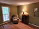 Relaxing living room featuring hardwood floors, a comfortable chair, and natural light at 3054 Whisper Knob Rd, Marietta, GA 30062
