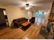 Bright living room featuring hardwood floors, a stone fireplace, and abundant natural light from large windows at 3054 Whisper Knob Rd, Marietta, GA 30062