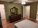 Main bedroom with hardwood floors, dark wood furniture, and three doors at 3054 Whisper Knob Rd, Marietta, GA 30062