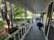Inviting covered front porch with fresh paint, complemented by plants and a view of the surrounding greenery at 3054 Whisper Knob Rd, Marietta, GA 30062