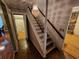 View of staircase featuring carpeted steps, classic chandelier, and hardwood floors in the entryway at 3054 Whisper Knob Rd, Marietta, GA 30062