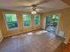 Sun-filled room with large windows, tile floors, and access to outdoor deck at 3054 Whisper Knob Rd, Marietta, GA 30062