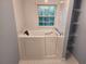 Close-up shot of a walk-in tub in a blue tiled bathroom, offering safety and accessibility at 3054 Whisper Knob Rd, Marietta, GA 30062