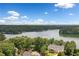 An elevated view reveals a house nestled among the trees, with a lake in the distance at 307 Little Hickory Ln, Woodstock, GA 30189