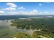 High angle of a sprawling lake surrounded by a vibrant, green forest under a sunny sky at 307 Little Hickory Ln, Woodstock, GA 30189
