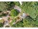 Aerial view reveals expansive property with house nestled among mature trees and a private driveway at 307 Little Hickory Ln, Woodstock, GA 30189