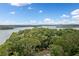 Aerial view of a lush tree canopy overlooking a beautiful blue lake at 307 Little Hickory Ln, Woodstock, GA 30189