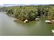 Aerial view of lakefront property with multiple boat docks and lush trees at 307 Little Hickory Ln, Woodstock, GA 30189