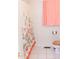 Simple bathroom features white tile flooring and floral shower curtain for a cozy atmosphere at 307 Little Hickory Ln, Woodstock, GA 30189