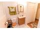This bathroom features a classic vanity with wooden accents and well-lit mirror at 307 Little Hickory Ln, Woodstock, GA 30189