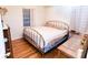 Bedroom with hardwood floors, a metal-frame bed, and classic furniture at 307 Little Hickory Ln, Woodstock, GA 30189