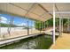 Covered boat dock on the water with swimming ladder and bridge at 307 Little Hickory Ln, Woodstock, GA 30189