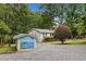 View of the house exterior and a small shed with a lake and fishing mural painted on the side at 307 Little Hickory Ln, Woodstock, GA 30189