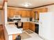 Traditional kitchen with wood cabinets and white appliances at 307 Little Hickory Ln, Woodstock, GA 30189