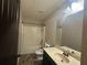 Traditional bathroom with a toilet, sink, mirror and bathtub at 443 Strawberry Walk, Loganville, GA 30052