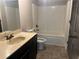 Modest bathroom featuring a bathtub, toilet, vanity and mirror at 443 Strawberry Walk, Loganville, GA 30052