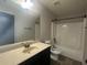Traditional bathroom featuring a sink, toilet, mirror, and bathtub at 443 Strawberry Walk, Loganville, GA 30052
