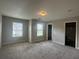 Bright, carpeted bedroom with neutral walls and ample natural light at 443 Strawberry Walk, Loganville, GA 30052