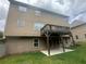 Back exterior view of the home with a deck above a patio and green lawn at 443 Strawberry Walk, Loganville, GA 30052