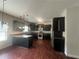 Modern kitchen with stainless steel appliances, granite countertops, and dark cabinets at 443 Strawberry Walk, Loganville, GA 30052
