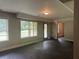 Spacious living room with bright lighting, large windows, and a door to the home's exterior at 443 Strawberry Walk, Loganville, GA 30052