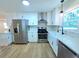 Modern kitchen with stainless steel appliances, white cabinets, and countertops at 705 Stewart Nw Cir, Marietta, GA 30064