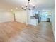 Open-concept living space showcasing hardwood floors, a modern chandelier, and a bright kitchen at 705 Stewart Nw Cir, Marietta, GA 30064