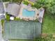 Aerial perspective of tennis court and pool with well-kept landscaping, plus covered seating areas at 1274 Branch Dr, Tucker, GA 30084