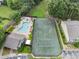 Overhead view of a tennis court and swimming pool, situated among mature trees at 1274 Branch Dr, Tucker, GA 30084