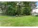 Expansive green backyard with mature trees and manicured landscaping, offering privacy at 1274 Branch Dr, Tucker, GA 30084