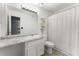 Bathroom with a white vanity, sink, toilet, and shower curtain at 1274 Branch Dr, Tucker, GA 30084