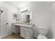 Bathroom with a white vanity, sink, toilet, and tiled floors at 1274 Branch Dr, Tucker, GA 30084