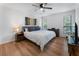 Bright bedroom featuring a ceiling fan, wood floors, and natural light from two windows at 1274 Branch Dr, Tucker, GA 30084