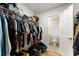 Walk-in closet with shelving and rods for storage, leading to an ensuite bathroom at 1274 Branch Dr, Tucker, GA 30084
