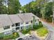 Two-story condo with light green and beige paint, featuring well-maintained landscaping around the property at 1274 Branch Dr, Tucker, GA 30084