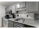 Updated kitchen with gray cabinetry, granite countertops, and modern appliances at 1274 Branch Dr, Tucker, GA 30084