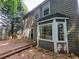 Backyard deck with stairs and access to an interior room and a large bay window for natural light at 180 Preston Oaks Dr, Johns Creek, GA 30022