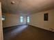 Open finished basement area with carpet and multiple windows providing natural light into the space at 180 Preston Oaks Dr, Johns Creek, GA 30022