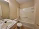 Bathroom featuring a single sink vanity, toilet, and tub with tile surround at 180 Preston Oaks Dr, Johns Creek, GA 30022