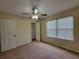 Bedroom featuring a ceiling fan, double hung window and carpeted floor at 180 Preston Oaks Dr, Johns Creek, GA 30022