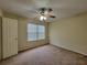 Bedroom with a ceiling fan, double hung window and neutral carpet at 180 Preston Oaks Dr, Johns Creek, GA 30022