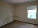 Bedroom with neutral walls, carpet and double hung window at 180 Preston Oaks Dr, Johns Creek, GA 30022