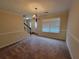 View of a dining room featuring neutral walls and carpet, modern light fixture, and crown molding at 180 Preston Oaks Dr, Johns Creek, GA 30022