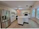 Kitchen featuring stainless steel appliances, white cabinetry, and a center island with views to the backyard at 180 Preston Oaks Dr, Johns Creek, GA 30022