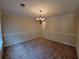 Living room featuring neutral walls and carpet, crown molding, and a modern light fixture at 180 Preston Oaks Dr, Johns Creek, GA 30022