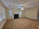 Bright living room with a fireplace, a ceiling fan, neutral walls, and natural light coming from the windows at 180 Preston Oaks Dr, Johns Creek, GA 30022
